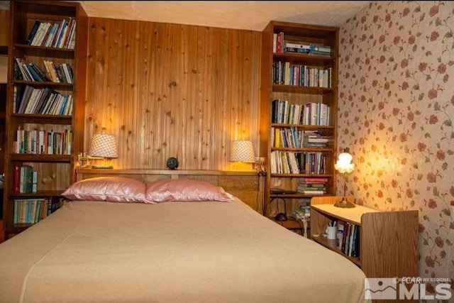 bedroom with wooden walls