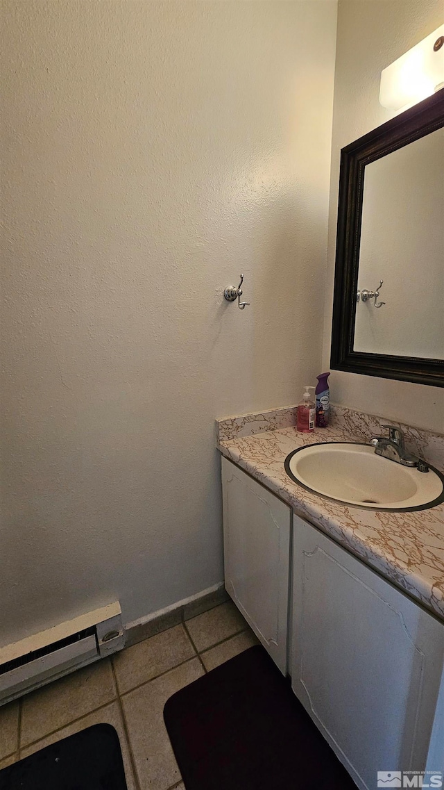 bathroom with vanity, a baseboard radiator, and tile patterned floors