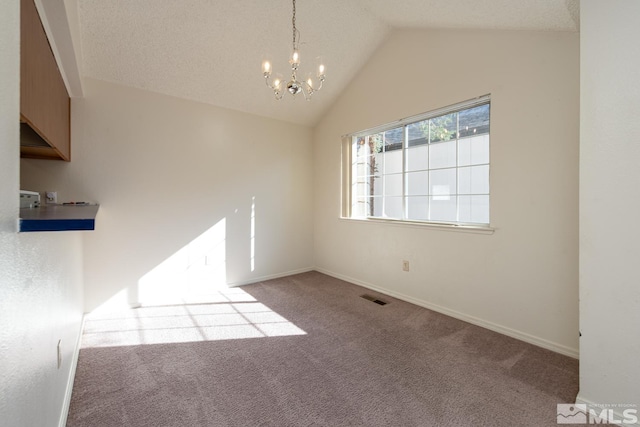 interior space with light carpet, lofted ceiling, a textured ceiling, and a chandelier