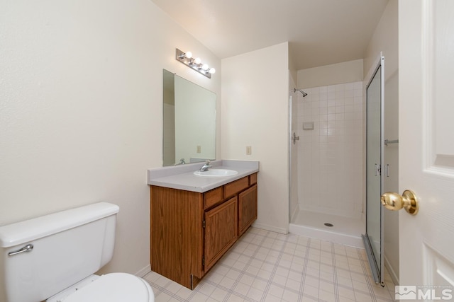 bathroom featuring vanity, toilet, and tiled shower