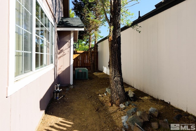 view of side of property featuring central air condition unit