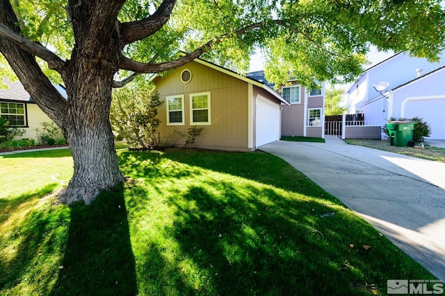 view of front of property with a garage and a front yard