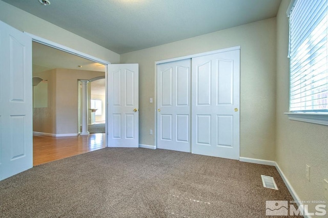 unfurnished bedroom featuring a closet and carpet floors