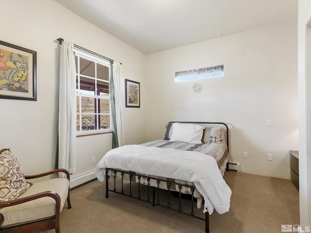 bedroom with baseboard heating and light colored carpet