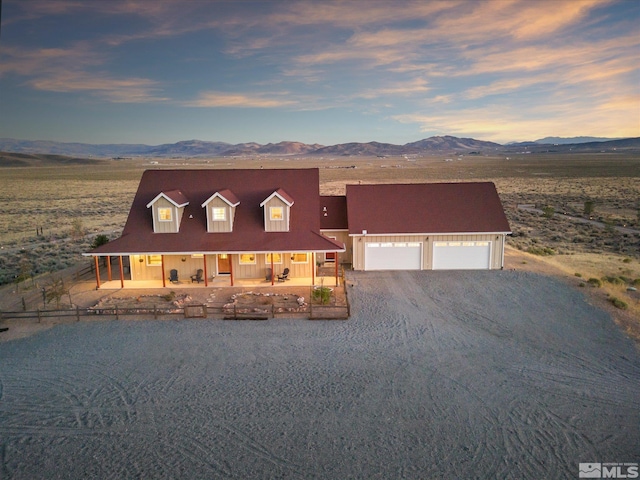 view of front of house with a mountain view, a garage, and a porch