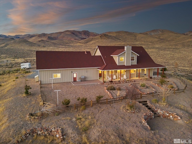 view of front of property featuring a porch and a mountain view