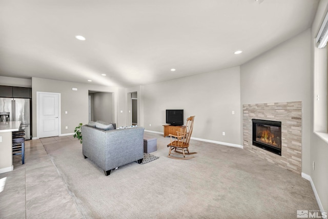 carpeted living room with a tile fireplace