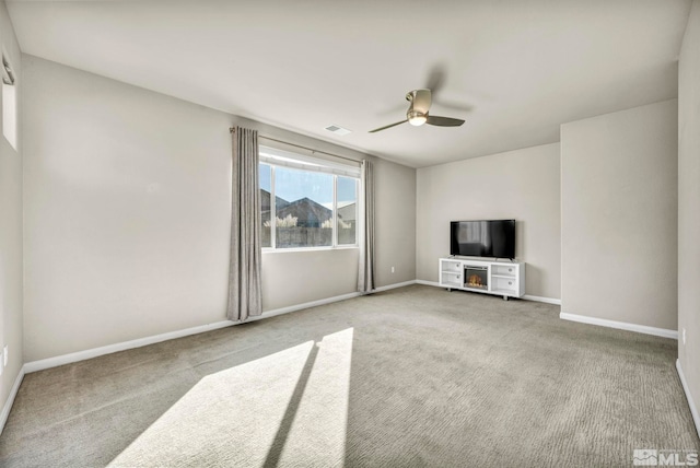 unfurnished living room featuring ceiling fan and carpet floors