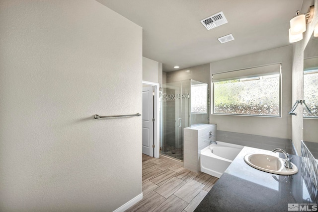 bathroom with vanity and plus walk in shower