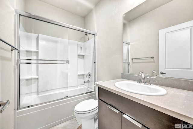 full bathroom featuring bath / shower combo with glass door, vanity, toilet, and tile patterned floors