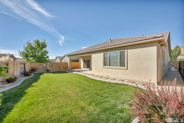 rear view of property with a lawn