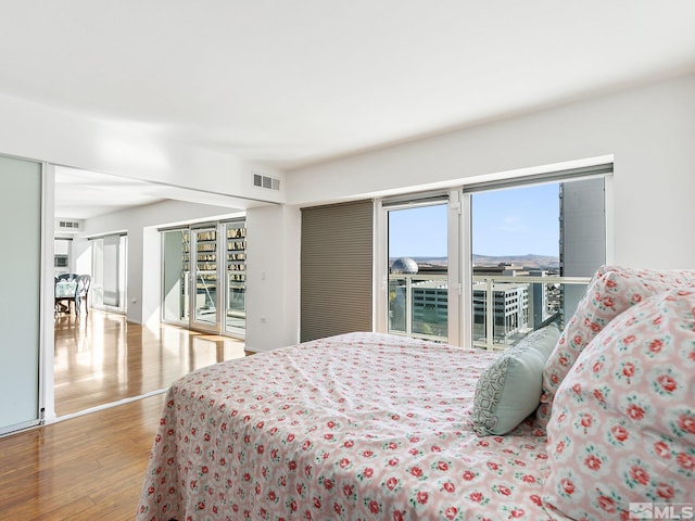 bedroom with light wood-type flooring and access to exterior