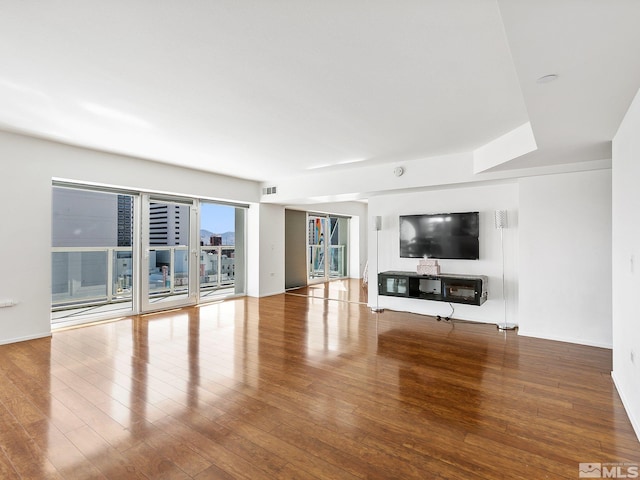 unfurnished living room featuring hardwood / wood-style flooring