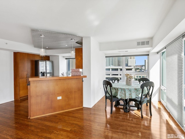 dining area with dark hardwood / wood-style flooring