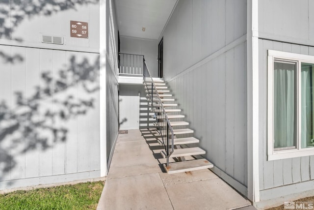 stairs with wooden walls and concrete floors