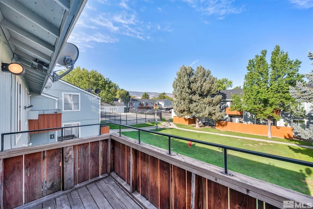 wooden deck with a lawn