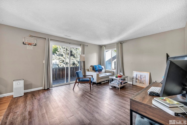 interior space with a textured ceiling and dark hardwood / wood-style flooring