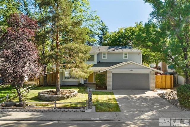 view of front of home with a garage and a front lawn