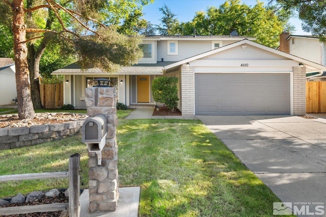 view of front of property with a garage and a front yard