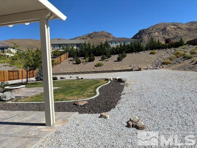 view of yard with a patio and a mountain view