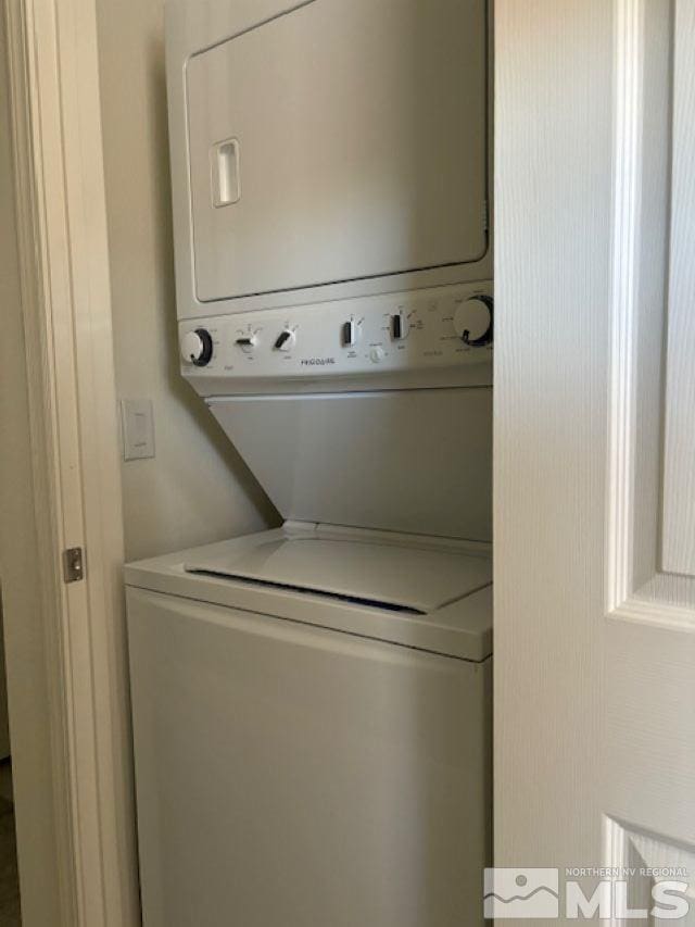 laundry area featuring stacked washer / dryer