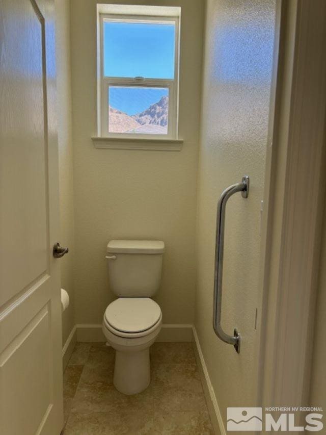 bathroom featuring toilet and tile patterned floors