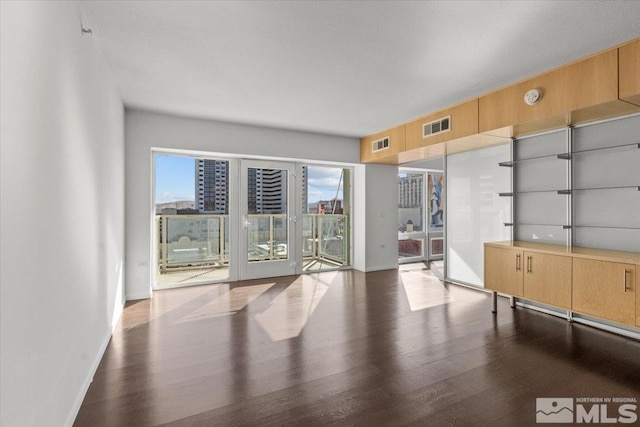 unfurnished room with wood-type flooring