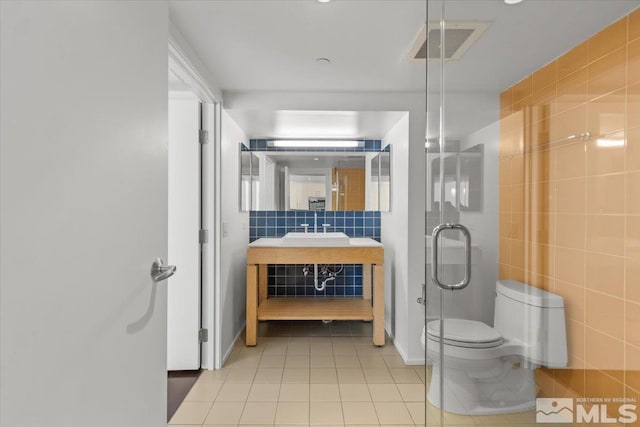 bathroom featuring tile walls, tile patterned flooring, vanity, and toilet