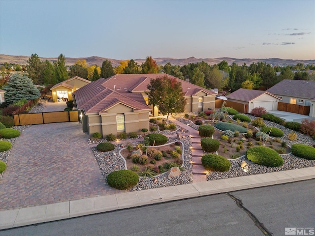 view of front of home with a mountain view and a garage