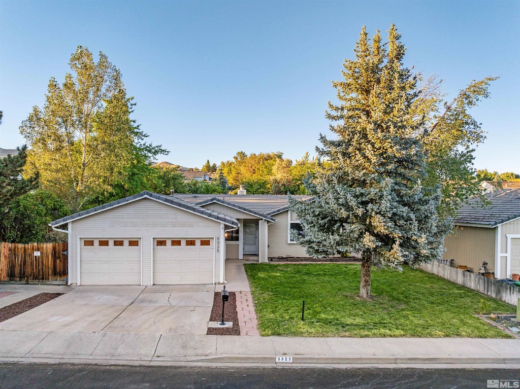 ranch-style home with a front yard and a garage