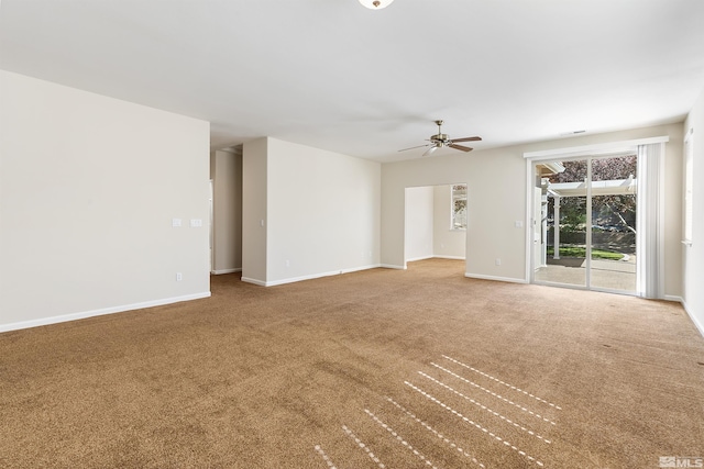 empty room featuring ceiling fan and carpet floors