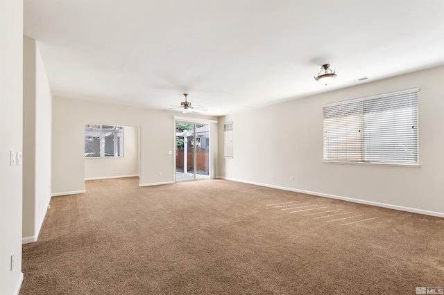 carpeted spare room with ceiling fan