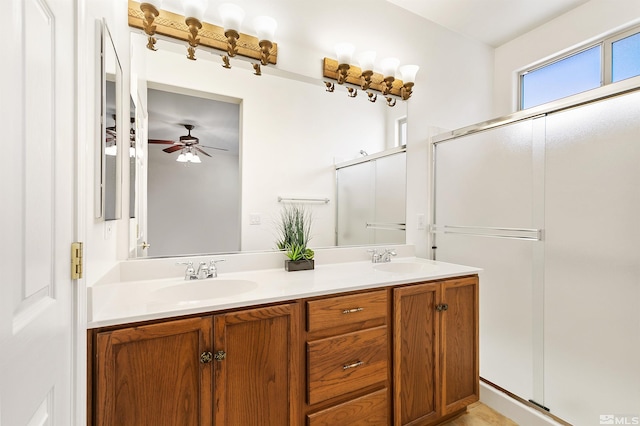 bathroom with ceiling fan, a shower with door, and vanity