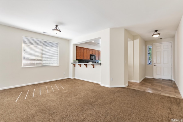 unfurnished living room featuring carpet