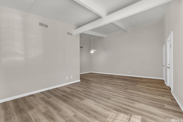 spare room with light hardwood / wood-style floors, beam ceiling, and ceiling fan