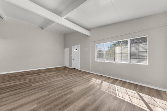 interior space with beam ceiling and hardwood / wood-style floors