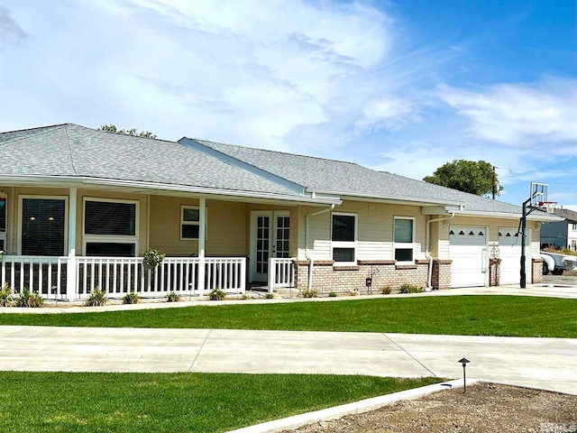 ranch-style home with brick siding, a porch, an attached garage, a front yard, and driveway