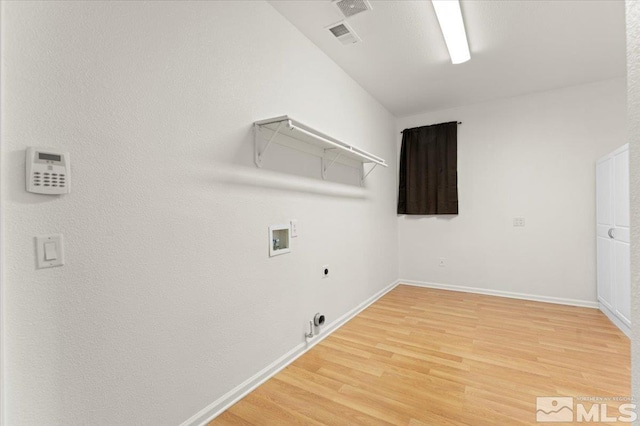 laundry area with hookup for an electric dryer, hookup for a gas dryer, hookup for a washing machine, and hardwood / wood-style floors