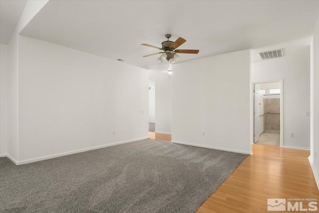 spare room with wood-type flooring and ceiling fan