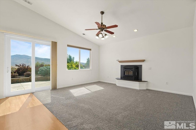 unfurnished living room with ceiling fan, a mountain view, and high vaulted ceiling