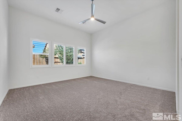 spare room featuring carpet flooring and ceiling fan