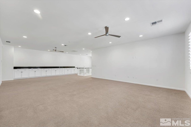 carpeted spare room with ceiling fan