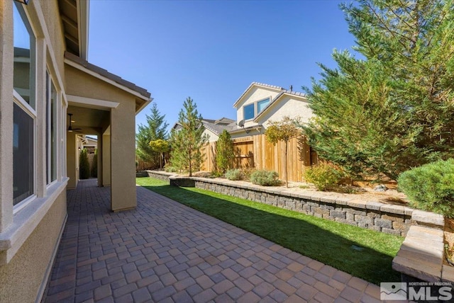 view of patio / terrace featuring ceiling fan