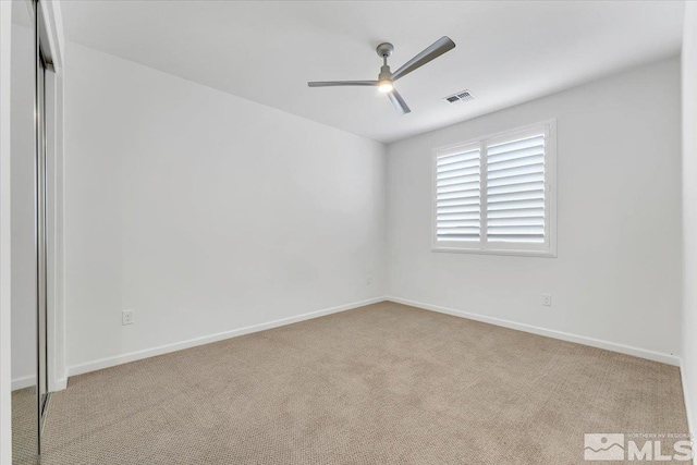 interior space featuring a closet, ceiling fan, and light colored carpet