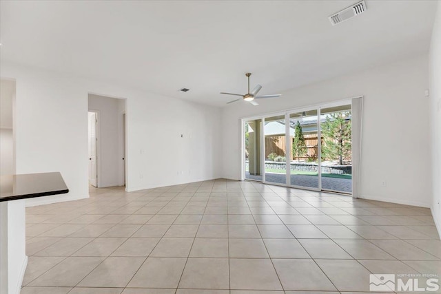 tiled empty room with ceiling fan