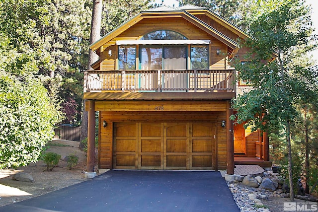 cabin with a balcony and a garage