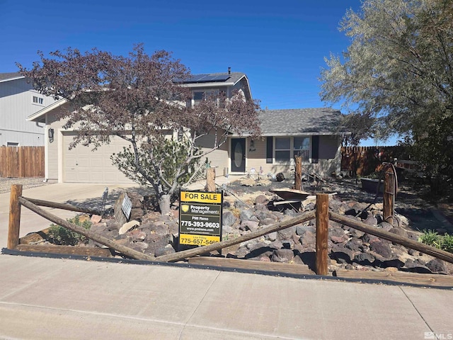 view of front of home with solar panels and a garage