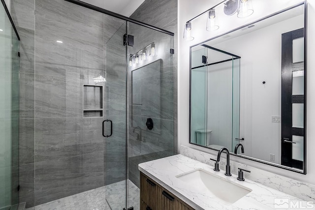 bathroom featuring vanity and an enclosed shower