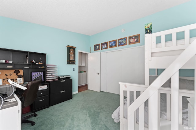 carpeted bedroom featuring a textured ceiling