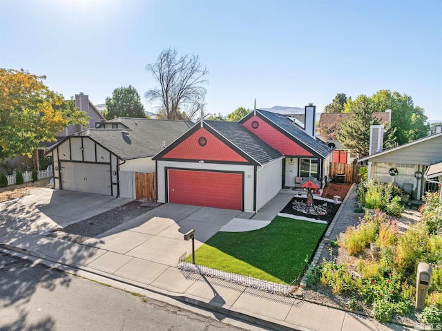 view of front of house featuring a garage and a front lawn